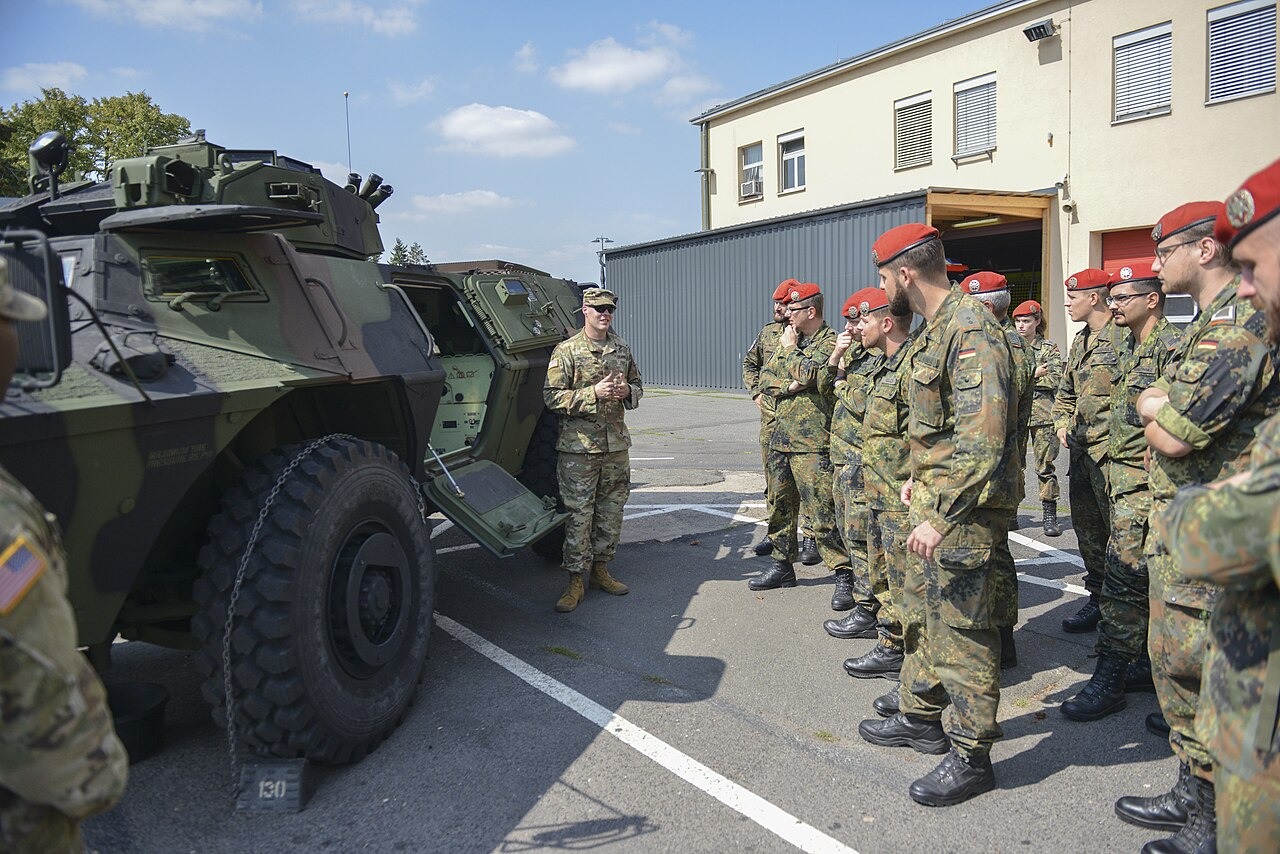 File photo: German military police personnel gather beside an armored security vehicle during a familiarization event in Germany. Illustrative context; not a photograph of the reported event.