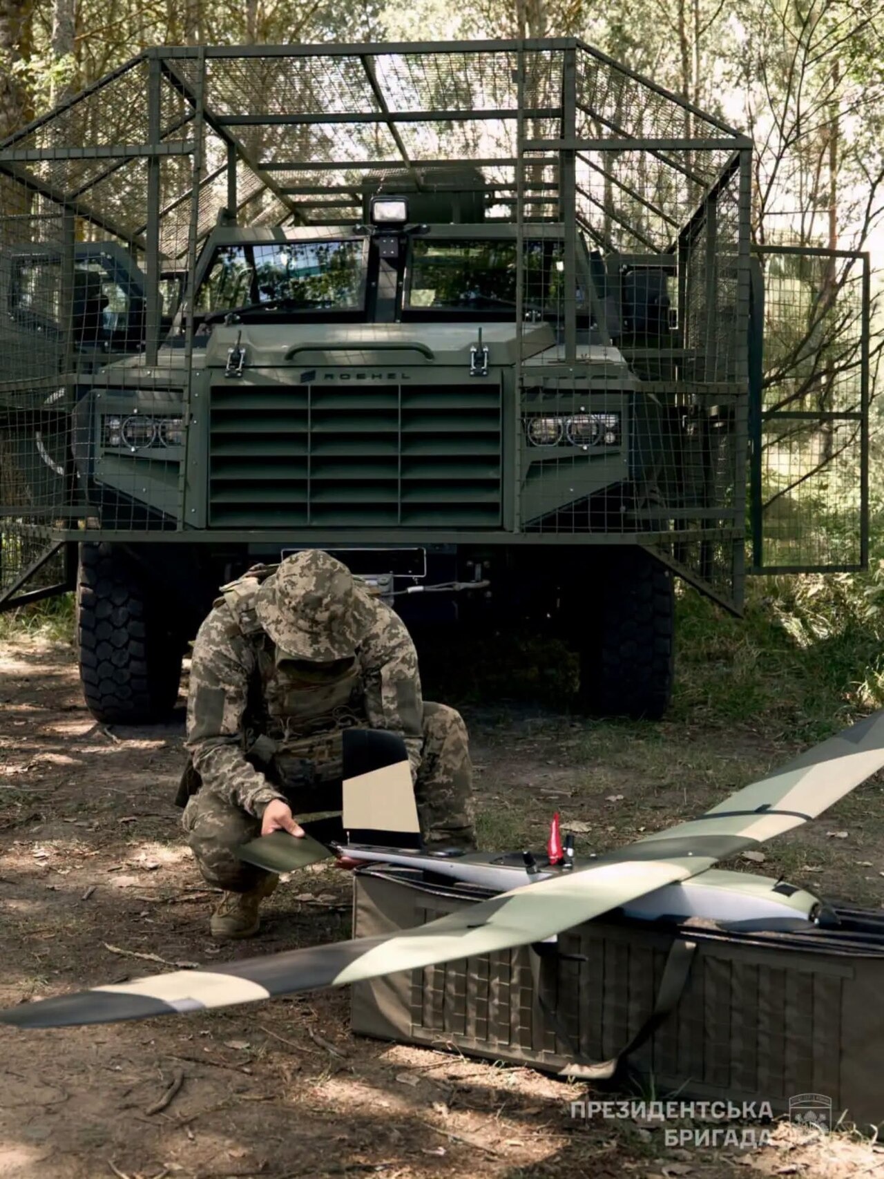 File photo: File photo of a Ukrainian servicemember beside a large unmanned aircraft and an armored vehicle. Illustrative context; not a photograph of the reported event.