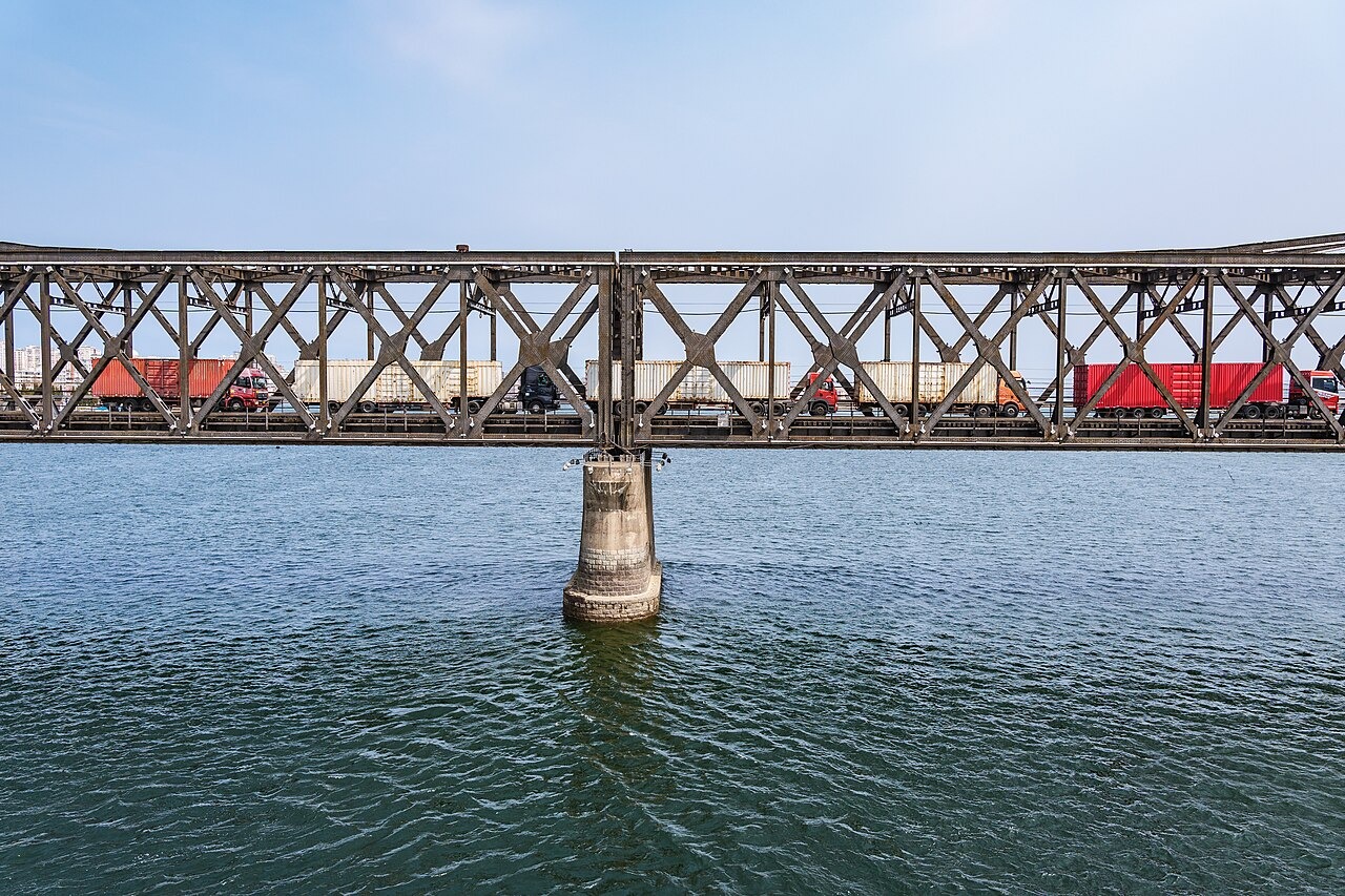 File photo: Cargo trucks cross the Sino-Korean Friendship Bridge between North Korea and China. Illustrative context; not a photograph of the reported event.